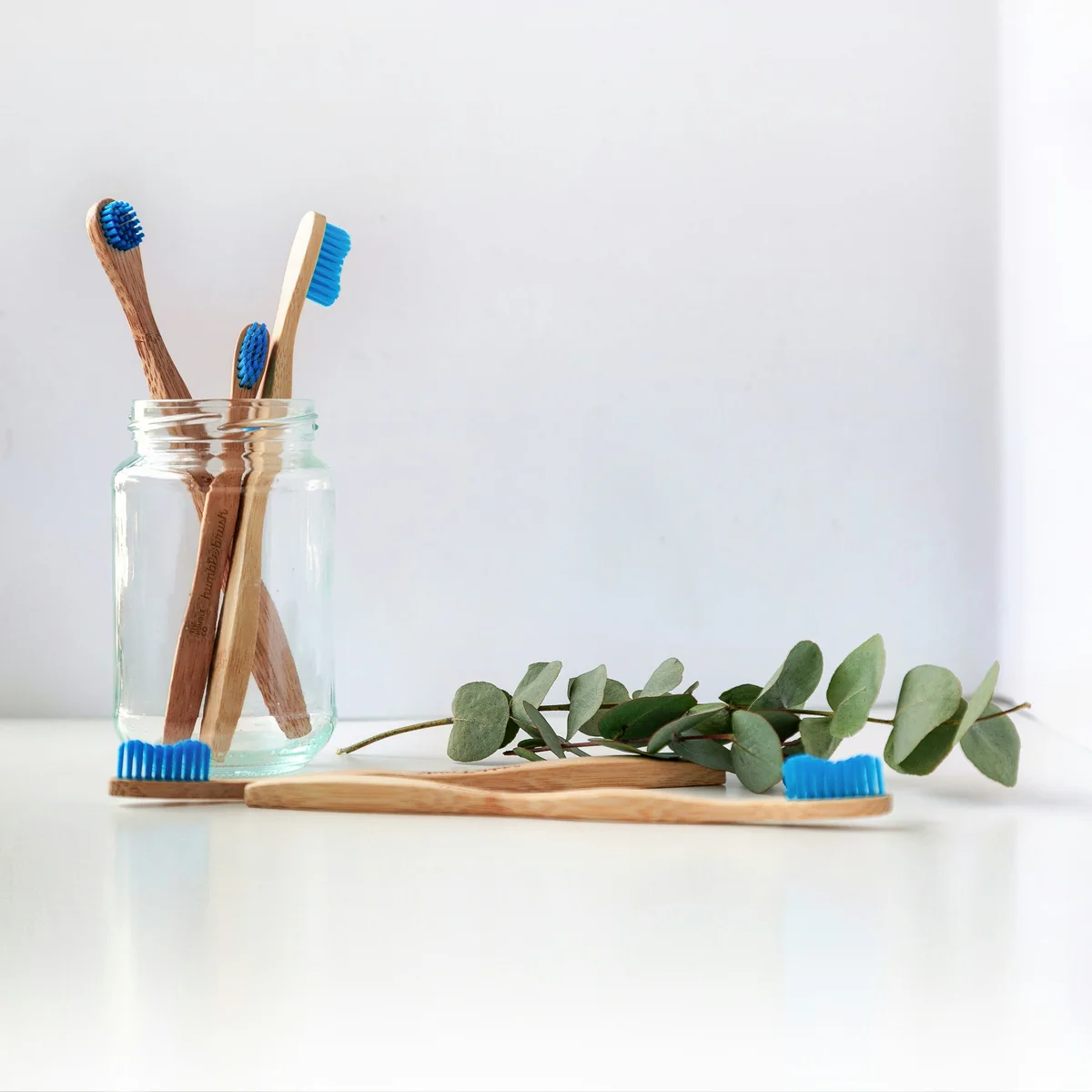 Natural wooden toothbrushes in ceramic cup